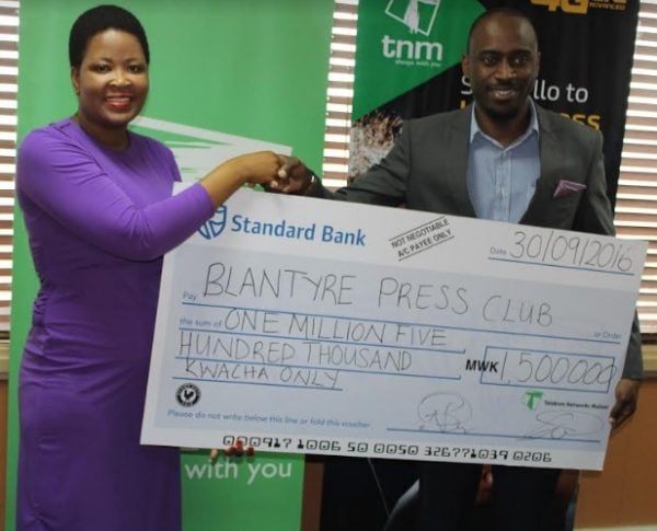 Here you are- Jonazi (R) presenting a cheque to Kazembe