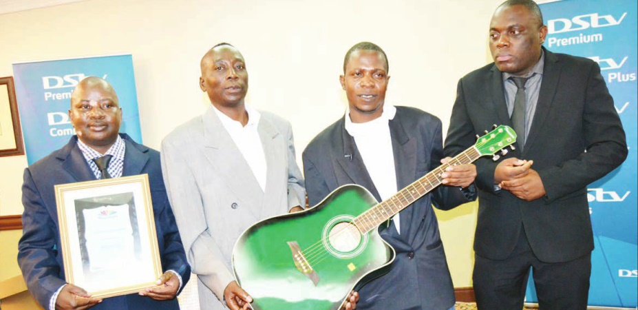 Nyirenda (R), Bindano (second from left), Salanje and prison spokesman Maliro pose with the guitar and certificate
