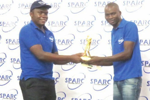 Chidale (right) receives a trophy from Phiri