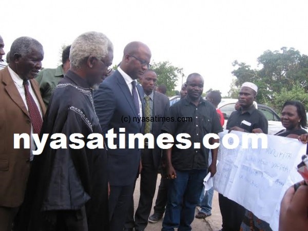 Muluzi accompanied by Kyungu reading one of the banners by the locals against Paladin.-Photo by Tiwonge Kumwenda, Nyasa Times