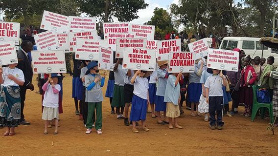 Young persons with albinism carrying placards
