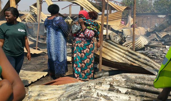 A woman weeps in the rubble of her destroyed shop. 