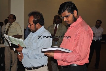 Members of the local business community look at documents during an interaction meeting with MRA recently
