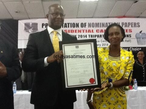 Atupele and his wife showing the certificate of presidential candidacy