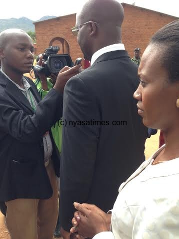 Atupele accompanied by his wife Angella speaking to reporters after vote