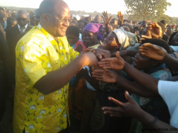 Atupele greet supporters prior to speaking during a whiste-stop meeting at Kasiya in Lilongwe