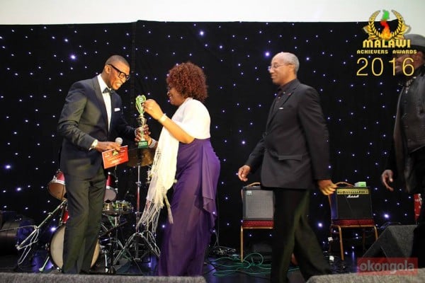 Against All Odds' Johnstone receives an award from Thom Twee at Malawi Achievers Awards UK