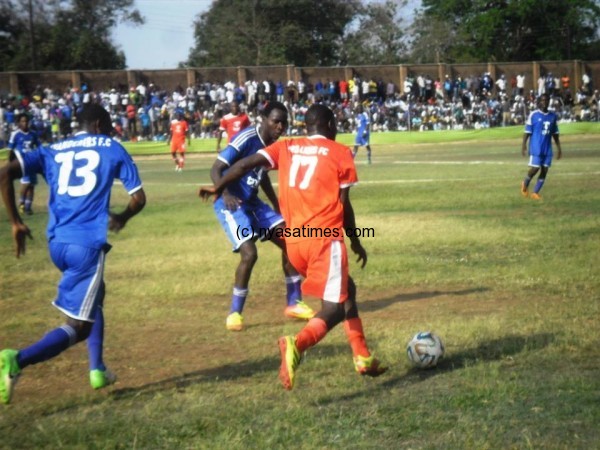 Mwambene (17) trying to dribble past two Nomads players