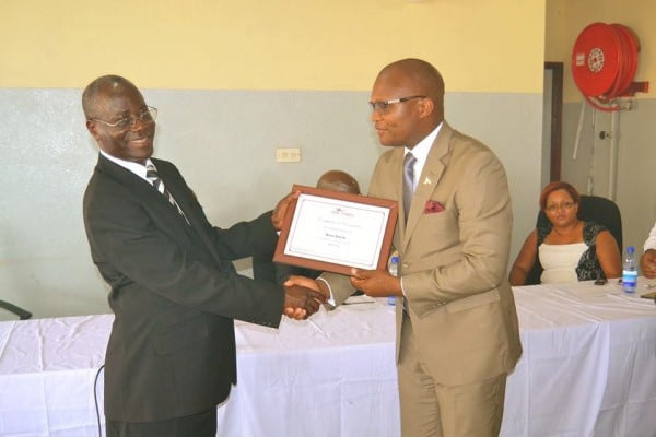 Brian Banda receives an award from Chikadya (Left), Times Group CEO