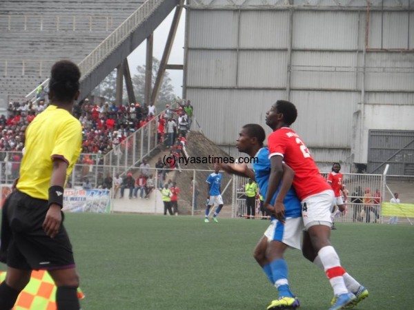 Tussling for the ball, Chikwawa player and Bullets