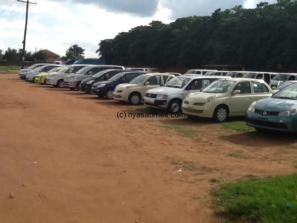 Second-hand cars from Japan parked at a roadside vehicle market in Biwi, Lilongwe. Credit: