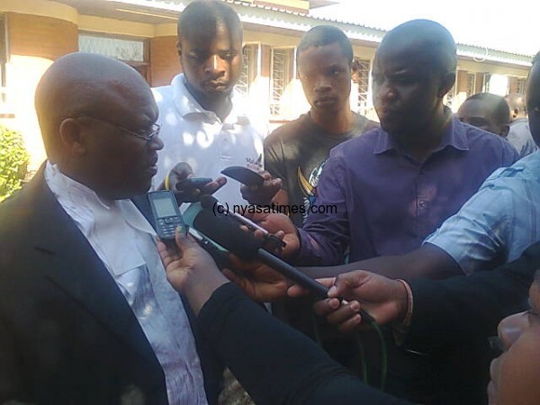 Lead prosecutor Chibwana speaking to reporters outside court
