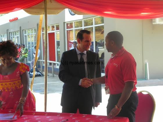 Total Malawi managing director (suit) and Chilima  during the signing ceremony