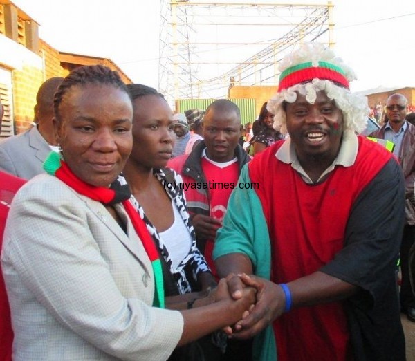 Sports Minister Chiumia with top  Flames fan Yona Malunga
