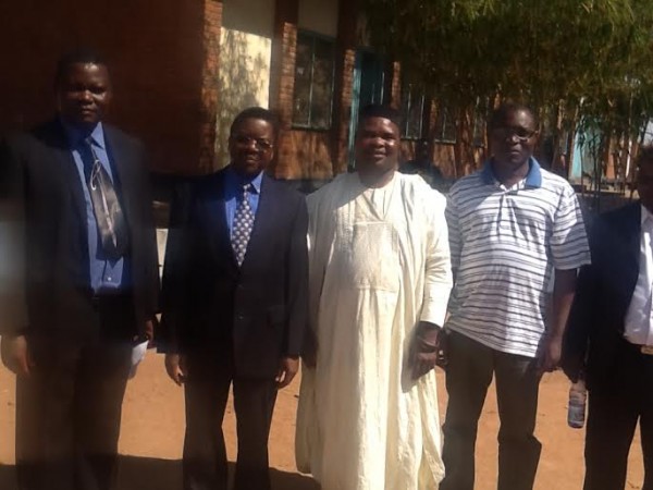 Alumini posing for a photo far left and second left is the the headteacher Mr Banda and Alumini chairperson Dr Kamdonyo.