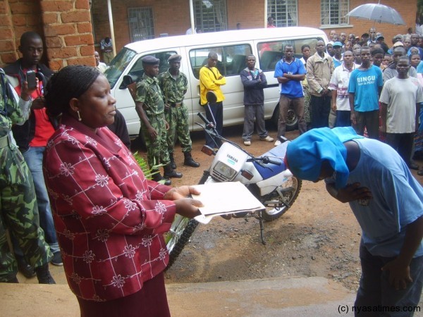 DPP supporter presenting the petition to Zomba DC official