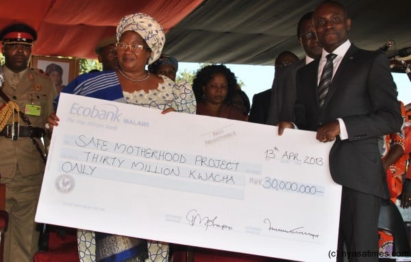 Ecobacnk's CEO presenting a dummy cheque to President Banda