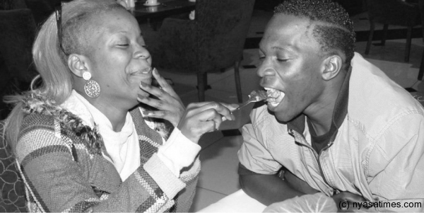 The controversial photo: Fatima feeding Armstrong at a 'friendly' lunch