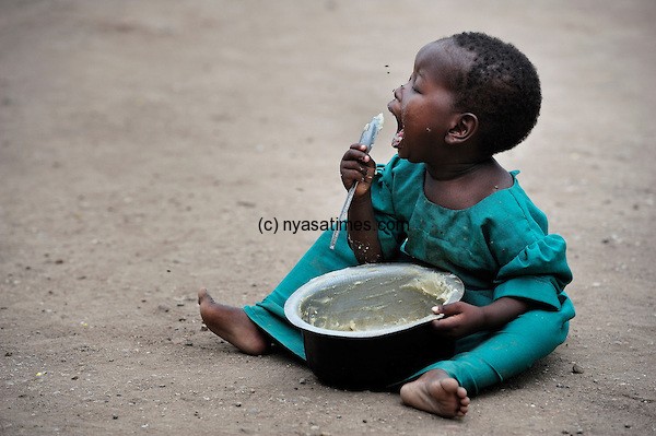 Malawi girl eats porridge