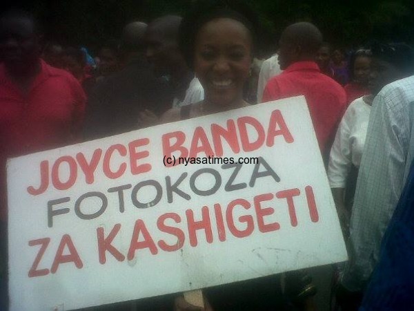 Protestor carrying a placard saying President Banda has to give answers on cashgate