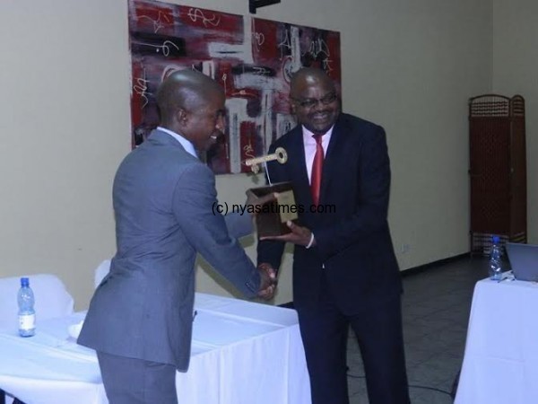 MEC’s spokesman Mwafulirwa receiving the award from Kasunda