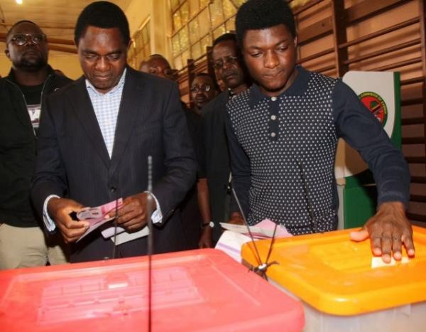 United Party for National Development (UPND) President candidate Hakainde Hichilema (L) and his son Habwela Hakainde cast their votes during the presidential and parliamentary elections in the capital, Lusaka, Zambia, August 11, 2016. REUTERS/Jean Serge Mandela