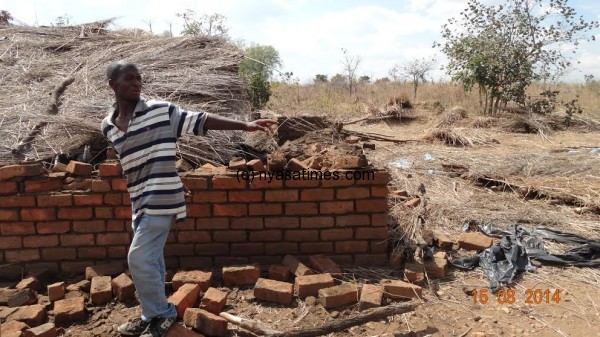One of houses demolished and the owner showing the officers: Courtesy of Balaka police  