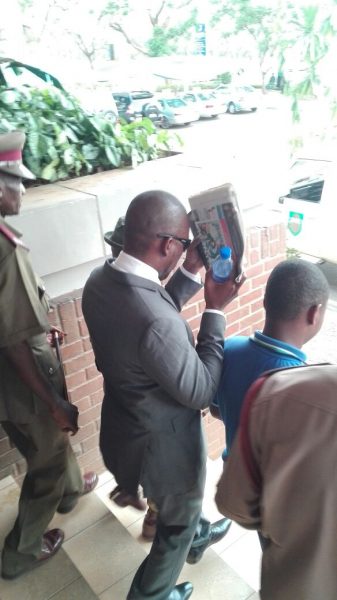 Cashgate convict Namata hides his face as he goes back to prison