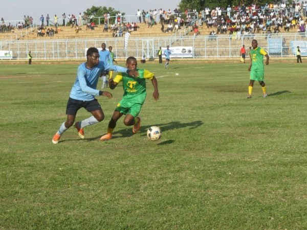 Duncan Nyoni attemps to beat a Dwangwa defender.