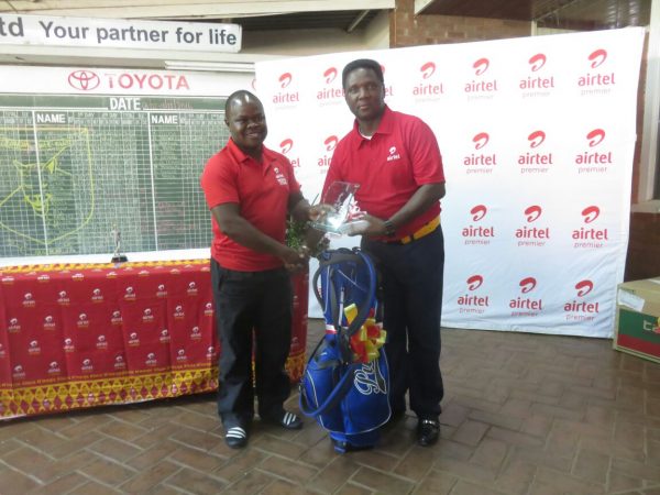 Elias Iman from Airtel presents prize to Msonthi Jnr