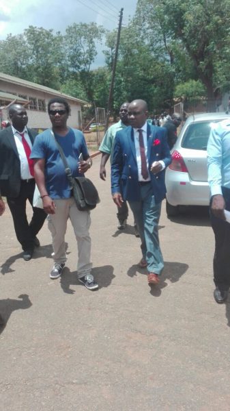 Mtumodzi with his surety Reuters journalist Mabvuto Banda (left) at Lilongwe Magistrate Court