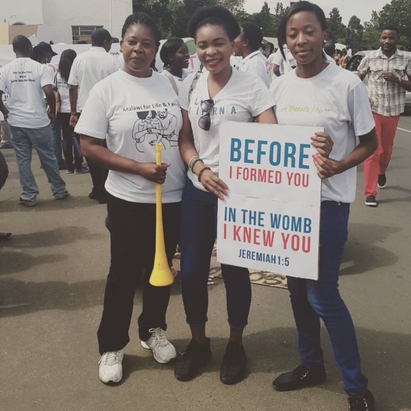 Marchers hold a placard in Blantyre