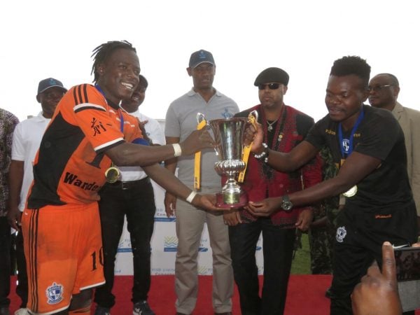 Nomads stand in captain Kamwendo, injured Captain Francis Mlimbika hold the cup as Chilima looks on, Pic Alex Mwazalumo