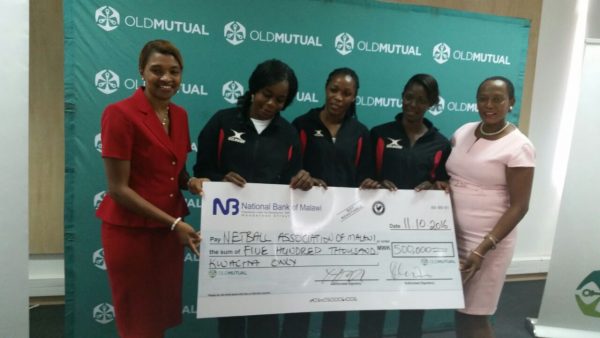 Phoya with Malawi Queens showing the cheque