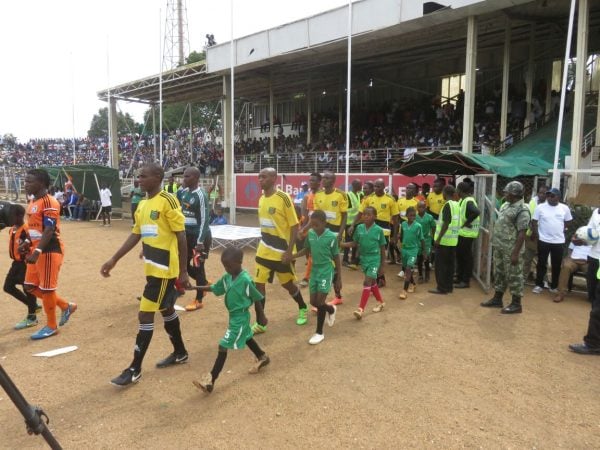 The teams walk to the pitch. - Photo by Alex Mwazalumo, NyASA tIMES