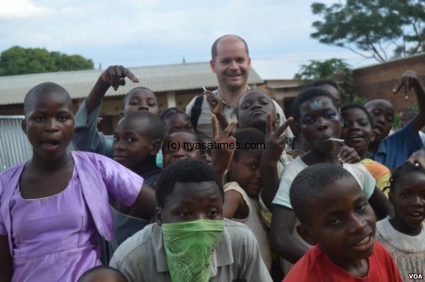 Director of Jacaranda School, Luc Deschamps with students (VOA/L. Masina)