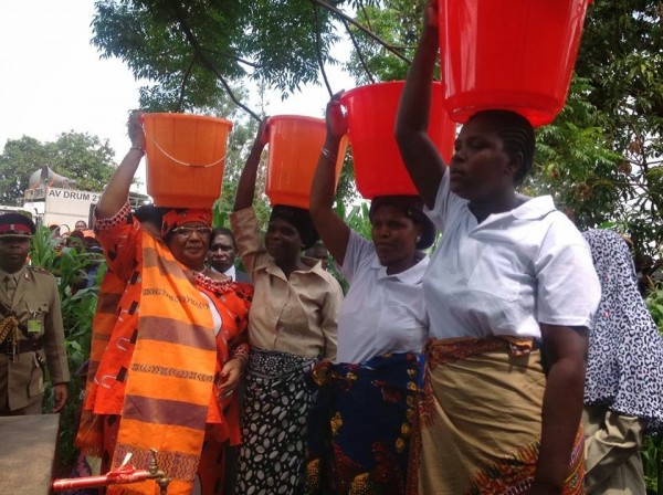 First: Joyce Banda while as President of Malawi carrying a bucket of water