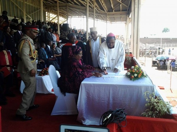 Joyce Banda Signing in the book of Peace Declaration before the PAC at Civo Stadium in Lilongwe