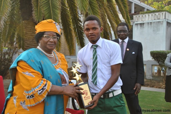 President Banda being shown the trophy