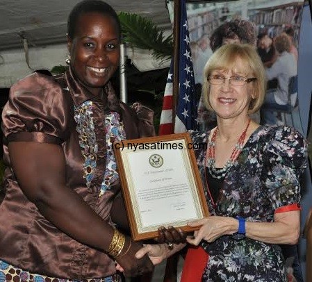 Kabwila with US ambassador showing off the certificate of nomination