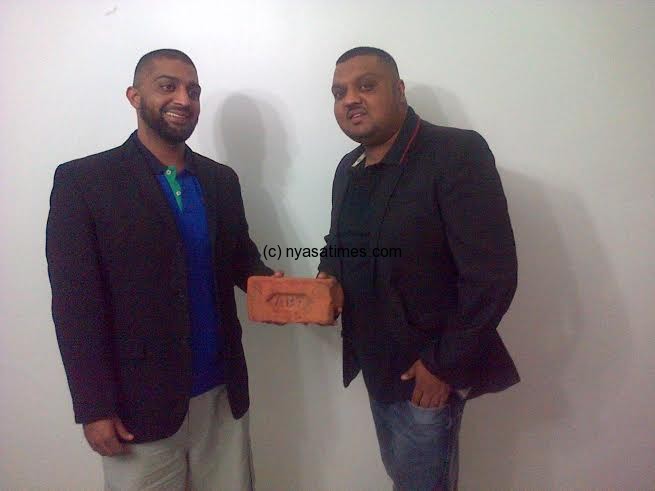 Jiwa showing one of the bricks with his co investor Mr Bilal Jiwa who is the operations director.