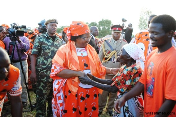 Woman of the people: Pres.Banda with a old lady whom she helped with maize donation in Nkhatabay