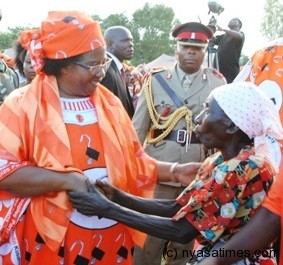 Woman of the people: Pres.Banda with a old lady whom she helped with maize donation in Nkhatabay