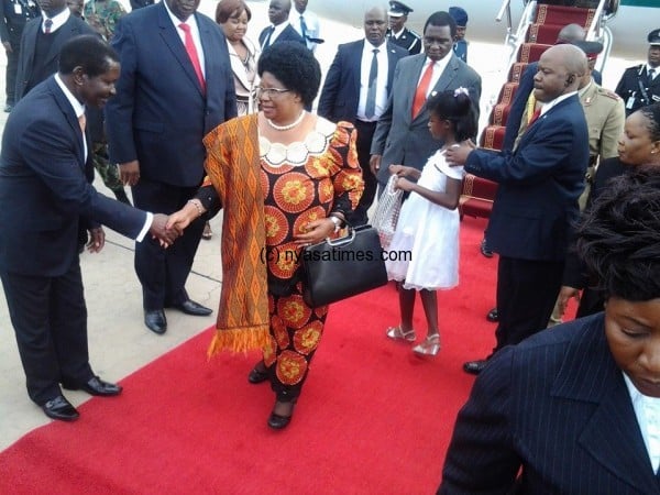 President Banda greeting Minister of Foreign Affairs Ephraim Chiume on arrival from Nigeria on Saturday