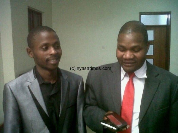 Journalist Mponda (left) with his lawyer Chancy Gondwe