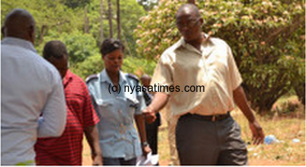 Charged with Money Laundering : Karonga (right) after court hearing