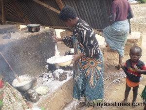 Guardians cooking for patients at a public hospital in Malawi