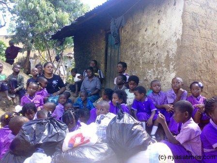 Little Chaps Acadamy pupils with the impoverished family where they presented the donation