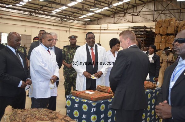 President Mutharika and Vice Presidet Chilima being briefed at JTI warehouse