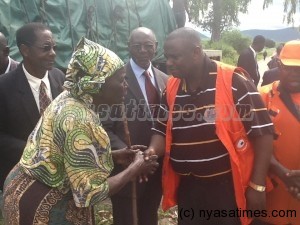 Presidential aide Rev Malani Mtonga greets a hailstorm victim in Karonga after presenting relief items from President Joyce Banda